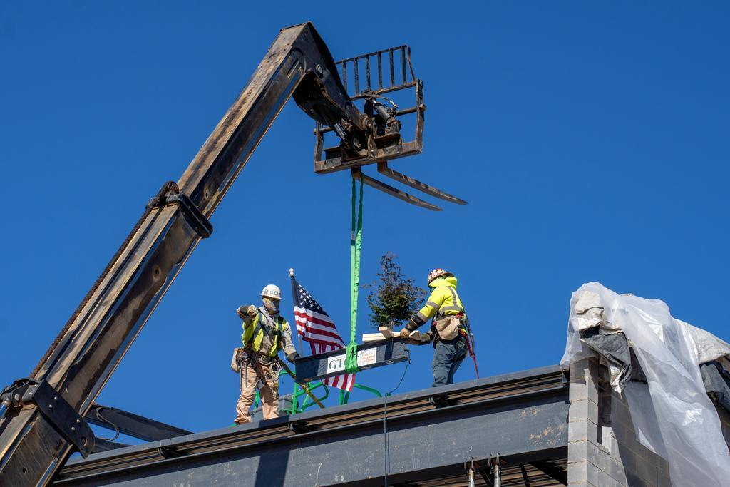 Blum construction workers putting the final beam on the GTCC Aviation Center