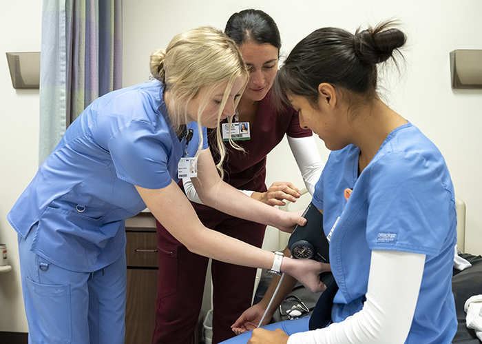 A nursing instructor with 2 female nursing students