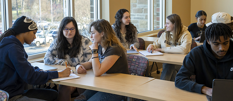 Students sit at tables working in a middle college class at GTCC.