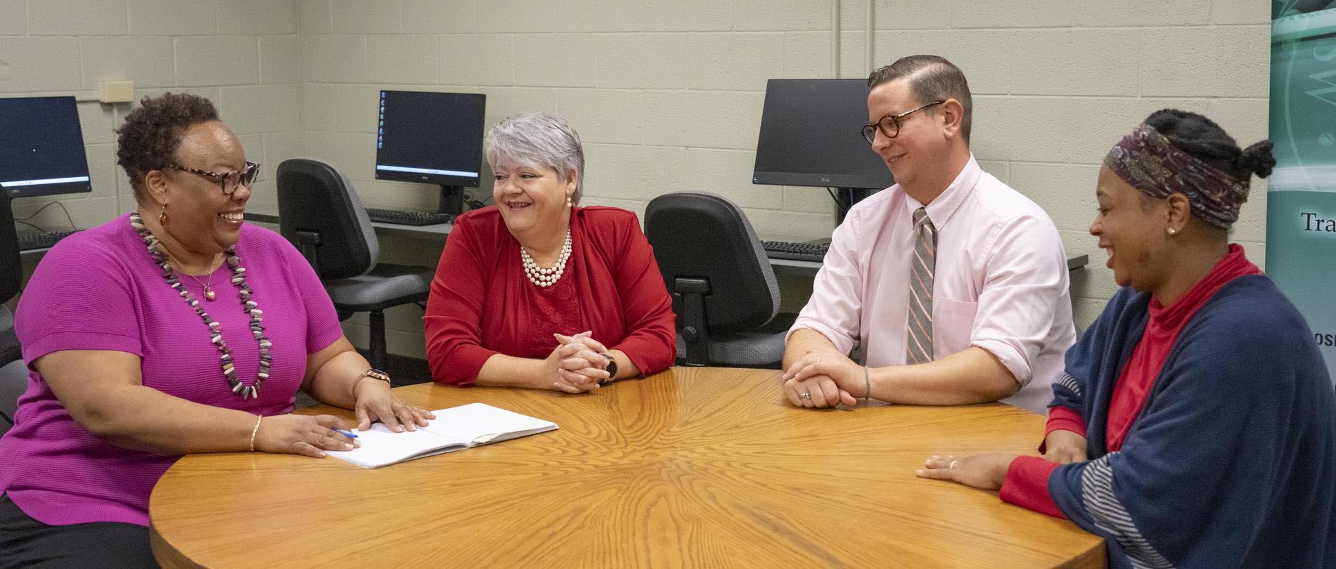 People sit around a table at the Small Business Center.