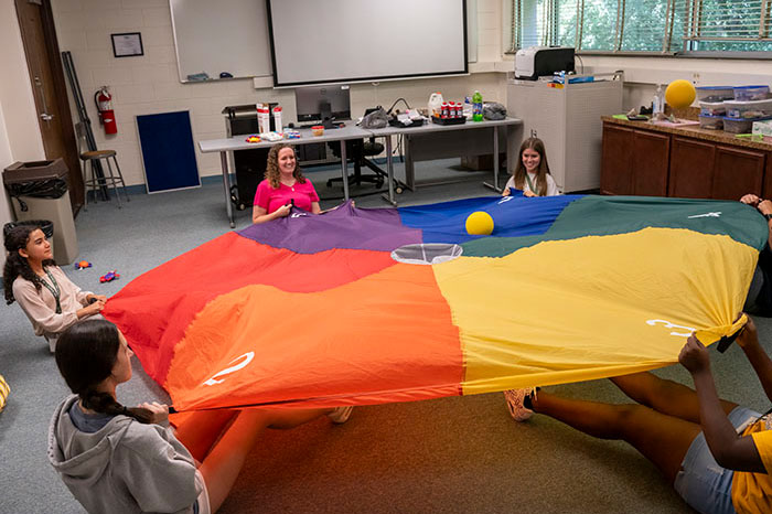 Future Educator students playing with a colorful parachute