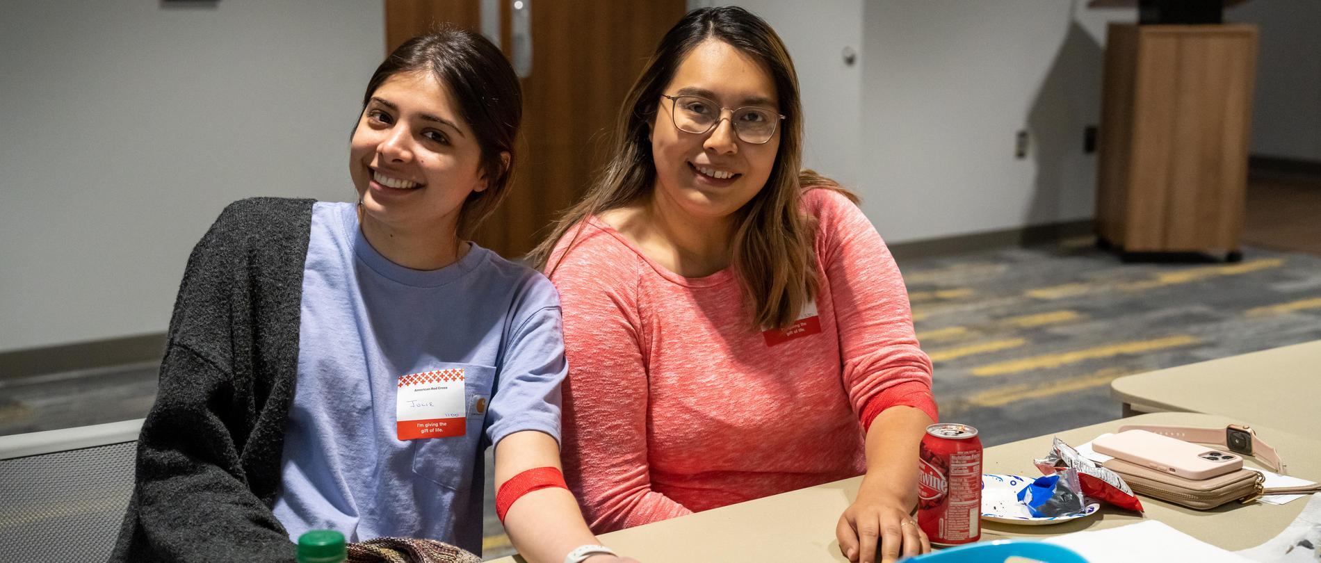 Two students have a snack after donating blood at GTCC.