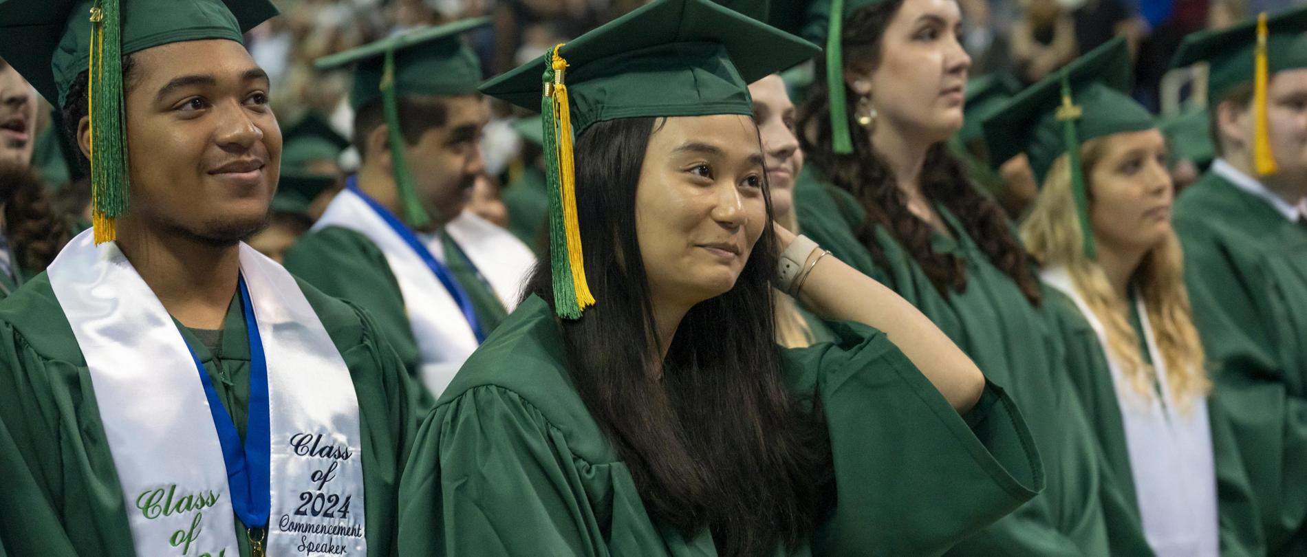 A graduation cap and tassel sitting on top of money