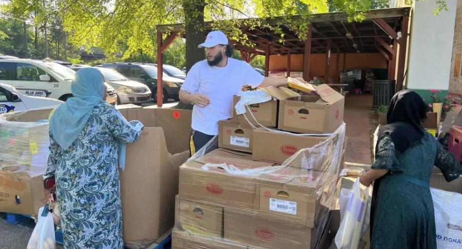 Akir Khan helps distribute food to refugees who are new to the U.S.