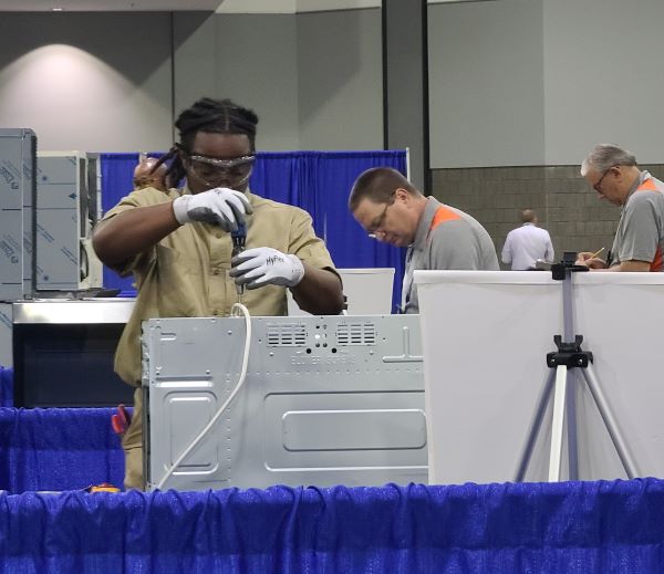 Jaiden Fraser (left), diagnoses an appliance at the national SkillsUSA competition in Atlanta, GA.