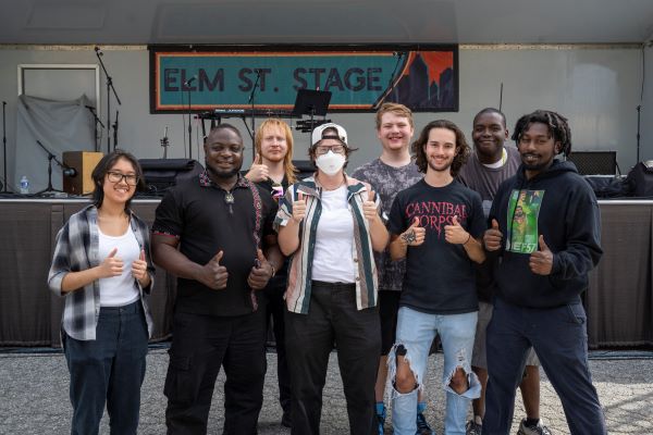 Group of entertainment technology students and faculty pose for a photo at the North Carolina Folk Fest.