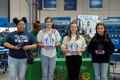 Third-place winner Quinerly Sheppard (Guilford County Schools/Northeast Middle), first-place winner Sofia Britt (Guilford County Schools/Mendenhall Middle), second-place winner Madison Hicks (Asheboro City School/Asheboro Middle), and winner for the most unique bridge design Siara Ghamrawy (Guilford County School/Brown Summit Middle).