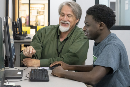 GTCC instructor helping a student with something on a computer