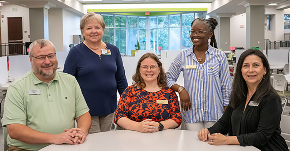 Academic achievement specialist viewing something from a student on a phone